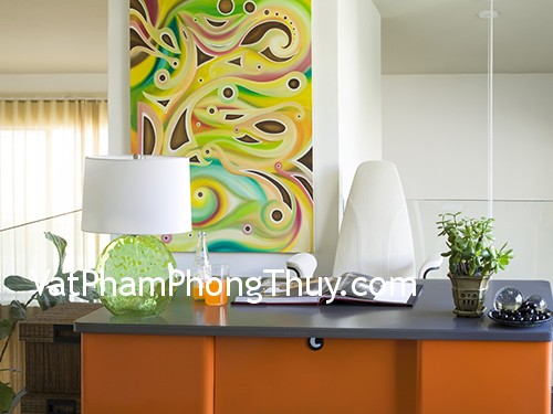 whimsical fun in this modern styled home office.a reclaimed metal desk from the 50's was repainted in this vibrant orange.other vibrant colors of lime in the glass desk lamp and multi colors in the original artwork give a sense of energy to the room.